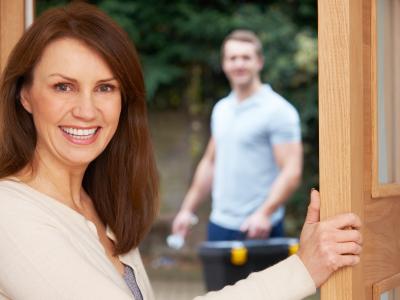 women with tradesperson at door